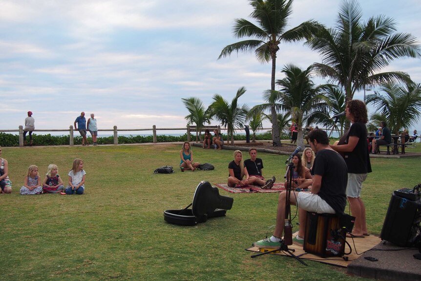 Melbourne musicians George Arnold (l) and Josh Thompson busking to a crowd at Cable Beach in Broome 17 July 2015
