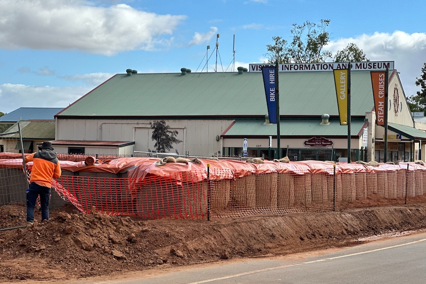 A large wall of sandbags next to a building