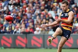 Brodie Smith kicks a ball with his right foot
