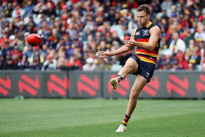 Brodie Smith kicks a ball with his right foot