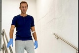 Russian opposition figure Alexei Navalny walks down stairs.