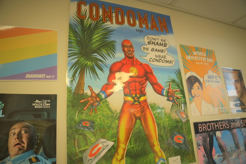A poster in a sexual health clinic reads Condoman 'Don't be shame, be game, wear condoms'. 