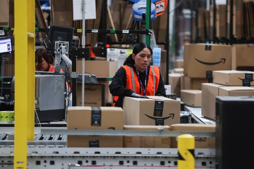 Photo of a worker preparing Amazon boxes 
