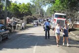 People help clean up a street which flooded in Rocklea on Brisbane's southside on January 16, 2011.