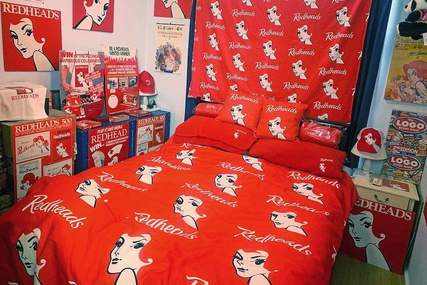A bedspread decorated with Redheads branding.