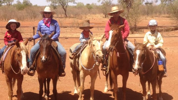 Abdy family photo in north Queensland with parents and three kids sitting on horses.