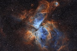 A close up of a nebula gas with orange and blue colours 