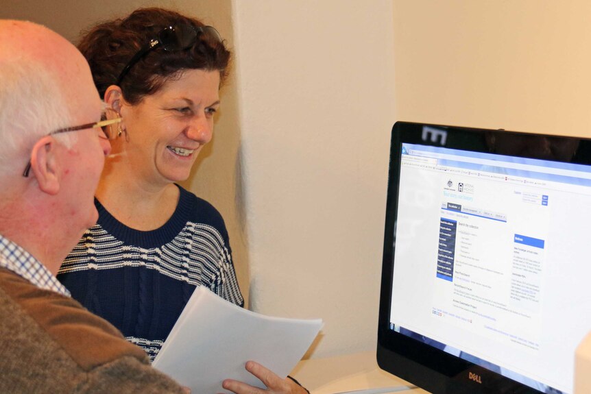 Volunteer Maurice Duke helps Meryl Broadbent find military service information on her father and uncle.