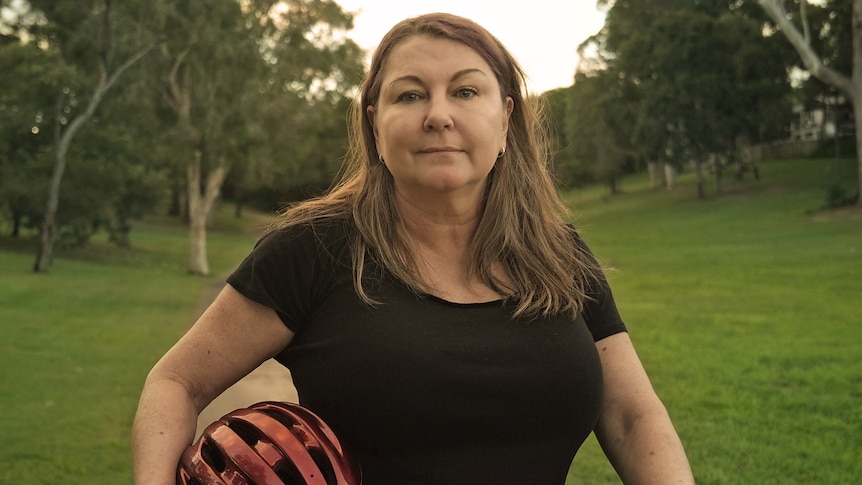 Caroline Deane stands next to her bike.