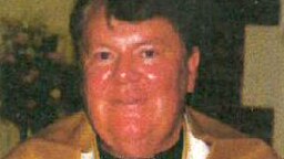 Close-up shot of priest Raymond Cheek wearing a gold robe