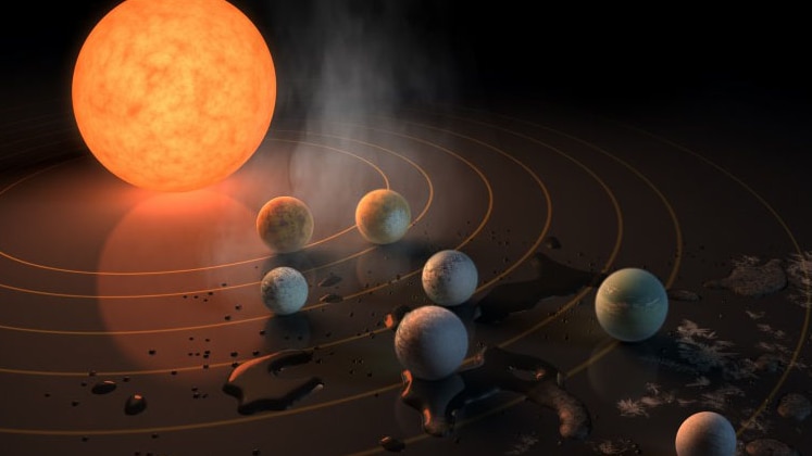 Artist's impression of TRAPPIST-1 with seven planets