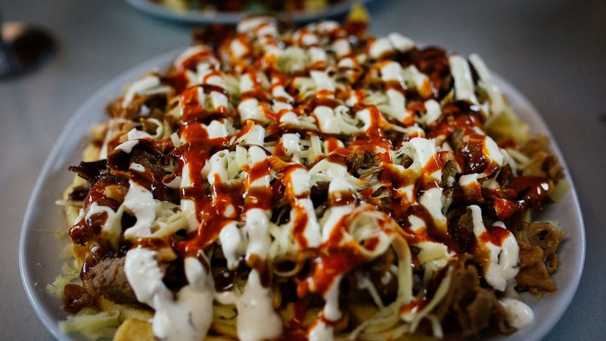 The beautiful red and white of chilli and garlic sauce on a halal snack pack.