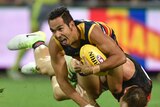 Eddie Betts holds onto the ball against Essendon