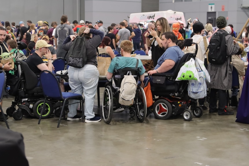 People sitting around the table with merch.