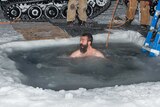 A member of the Antarctic Division's Davis research station team takes a plunge to mark the 2014 winter solstice.