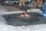 A member of the Antarctic Division's Davis research station team takes a plunge to mark the 2014 winter solstice.