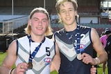 Harley Reid and Ollie Murphy pose for a photo, both wearing medals around their necks