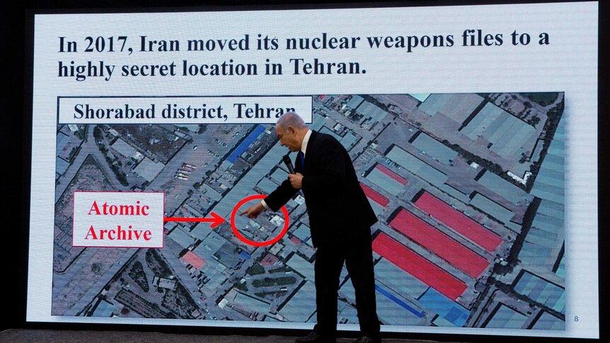 Israeli Prime Minister Benjamin Netanyahu points to a map showing where the secret files are stashed.