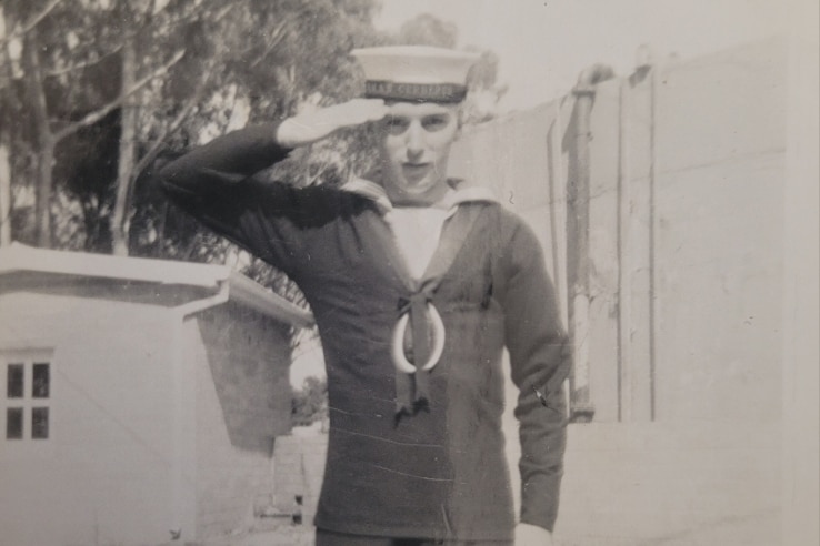 A vintage photo of a sailor saluting