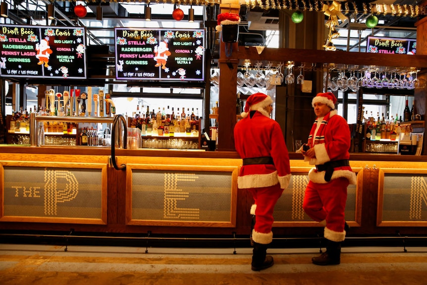 Two Santas in a bar during SantaCon