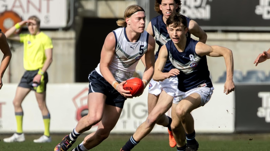 Footballer Harley Reid carries the ball forward for Victoria Country