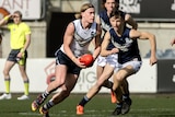 Footballer Harley Reid carries the ball forward for Victoria Country