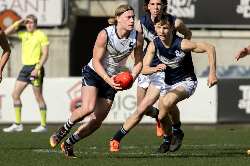 Footballer Harley Reid carries the ball forward for Victoria Country