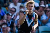 Jason Horne-Francis pumps his right fist during an AFL match.
