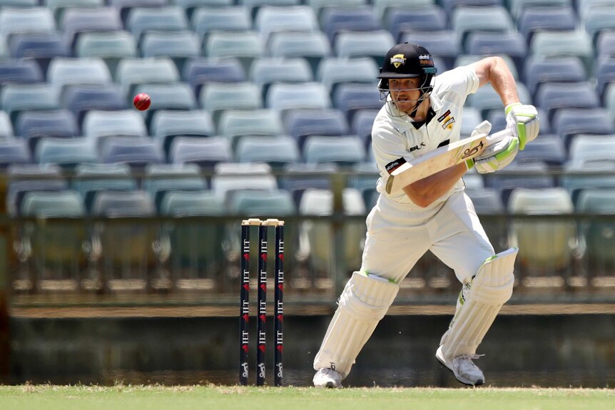 Cameron Bancroft guides the ball away for Western Australia