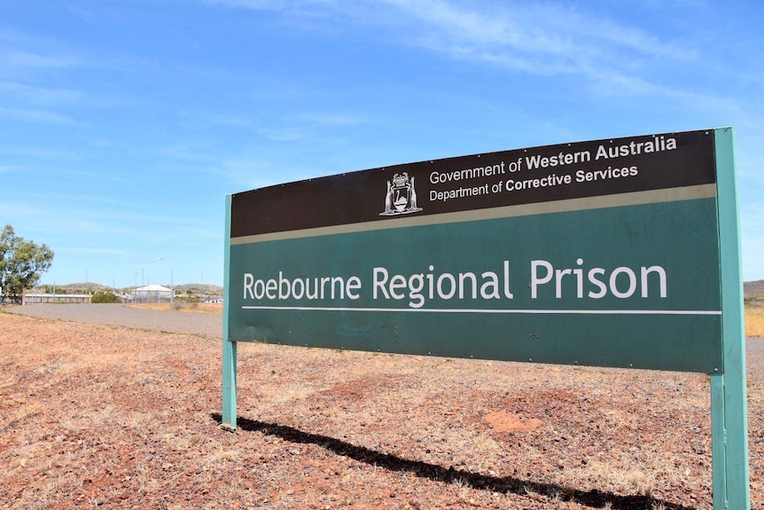 A sign in the desert that reads "Roebourne Regional Prison".