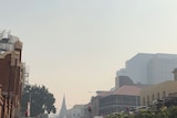 A smoky street in Hobart - the buildings in the foreground are in focus but gradually get lost in the distance