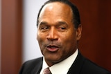 A close-up of OJ Simpson wearing a suit.