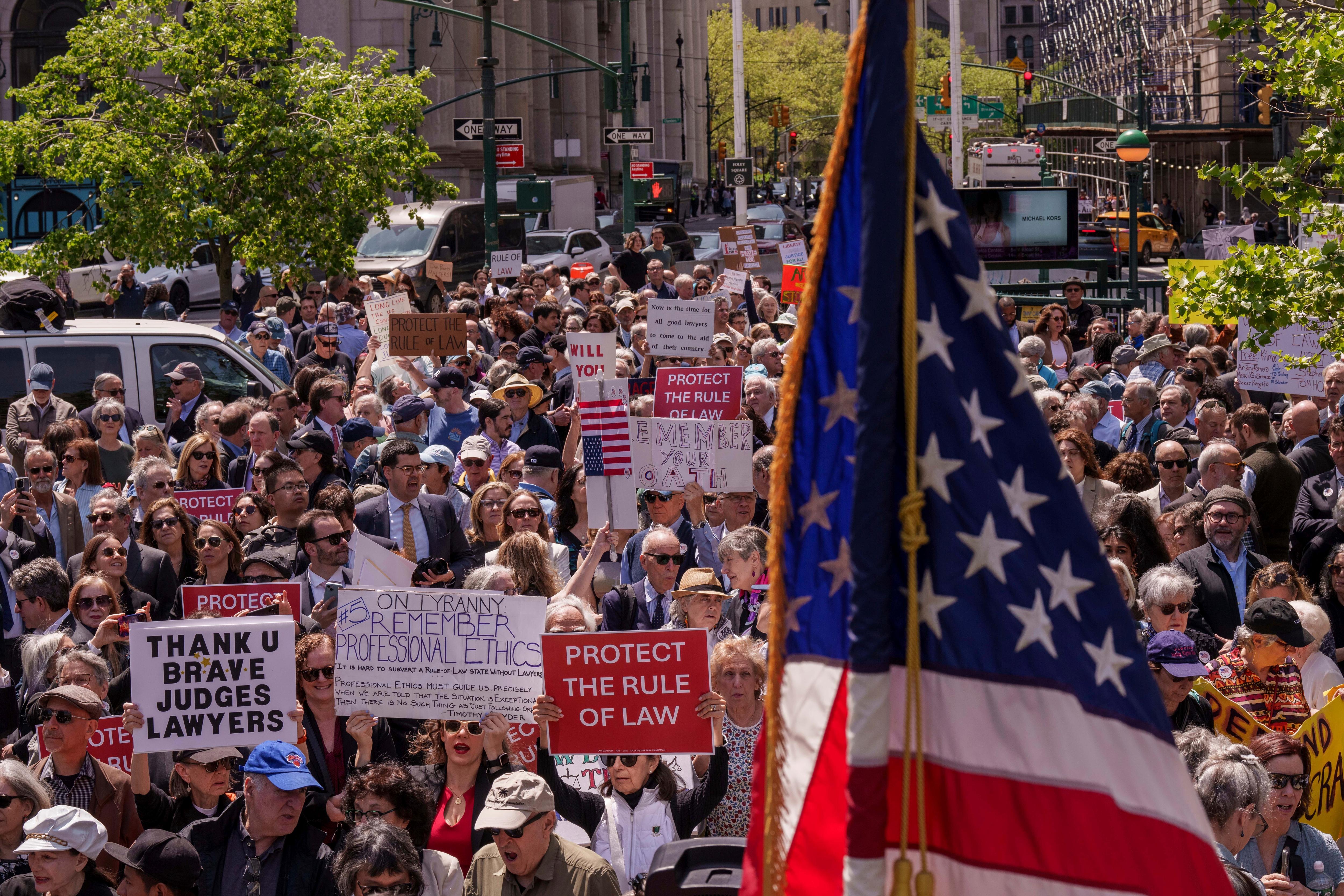 A crowd in front of a US flah 