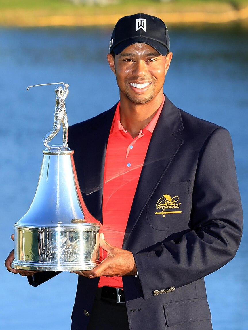 Tiger Woods holds the trophy after winning the 2012 Arnold Palmer Invitational.