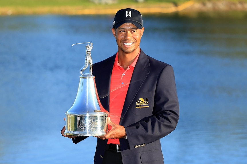 Tiger Woods holds the trophy after winning the 2012 Arnold Palmer Invitational.
