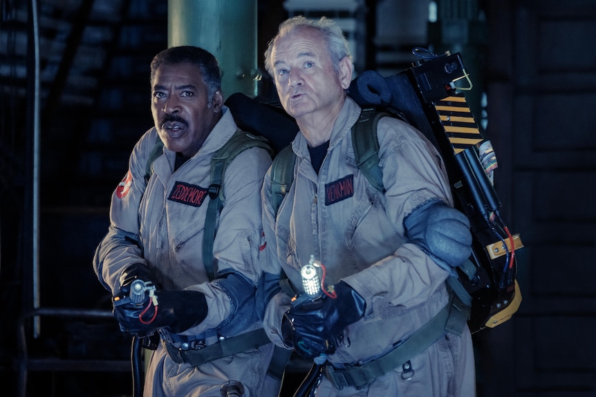 Two men in ghostbusters suits with proton packs