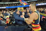 Taylor Walker of the Crows celebrates with the crowd after Adelaide's match with Geelong.