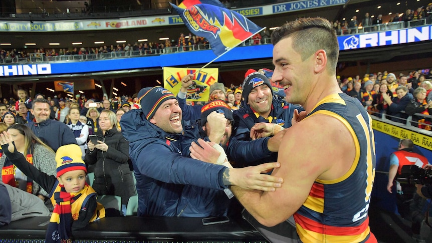 Taylor Walker of the Crows celebrates with the crowd after Adelaide's match with Geelong.