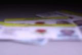 a blurred photo of nsw drivers licenses