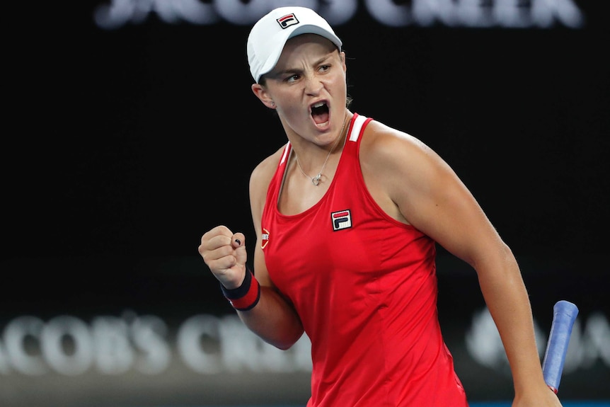Ashleigh Barty pumps her left fist after winning a point against Camila Giorgi at the Australian Open.