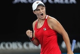 Ashleigh Barty pumps her left fist after winning a point against Camila Giorgi at the Australian Open.