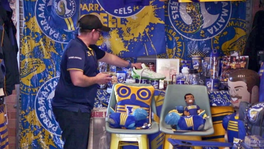 Troy Warner stands in his garage, which is decked out with Parramatta Eels paraphernalia