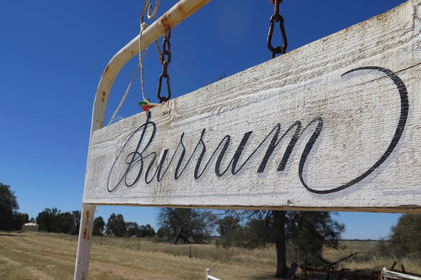 rusted farm sign with the words 'Burrum' on it at the entrance to the farm