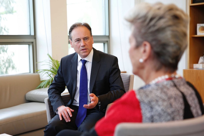 Health Minister Greg Hunt speaking with the Mayor of Katherine, Fay Miller, who has her back to the camera