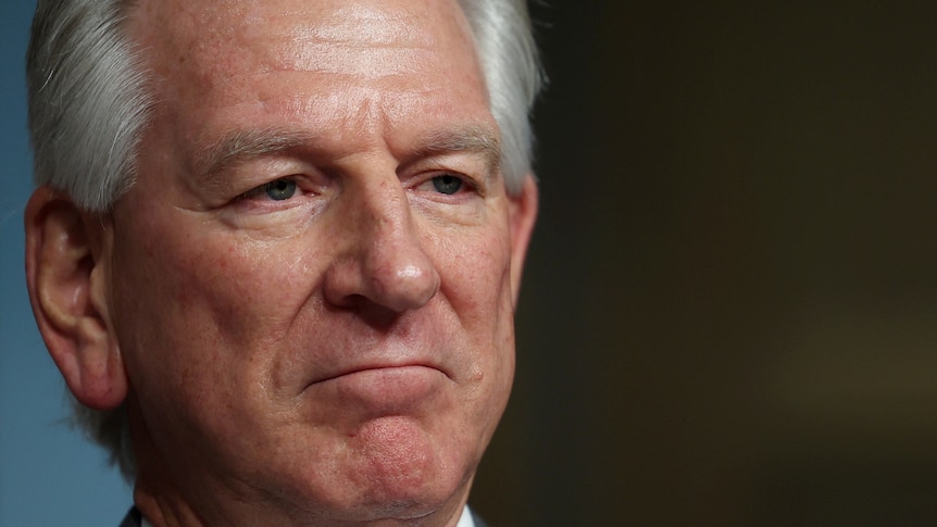 Tommy Tuberville frowns in a close-up headshot.