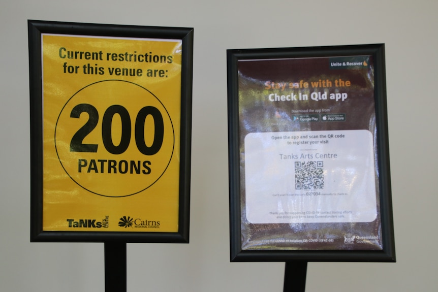 a sign showing 200 patrons and a COVID QR code check in