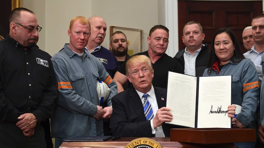 Donald Trump made the announcement flanked by steel and aluminium workers (Photo: AP/Susan Walsh)