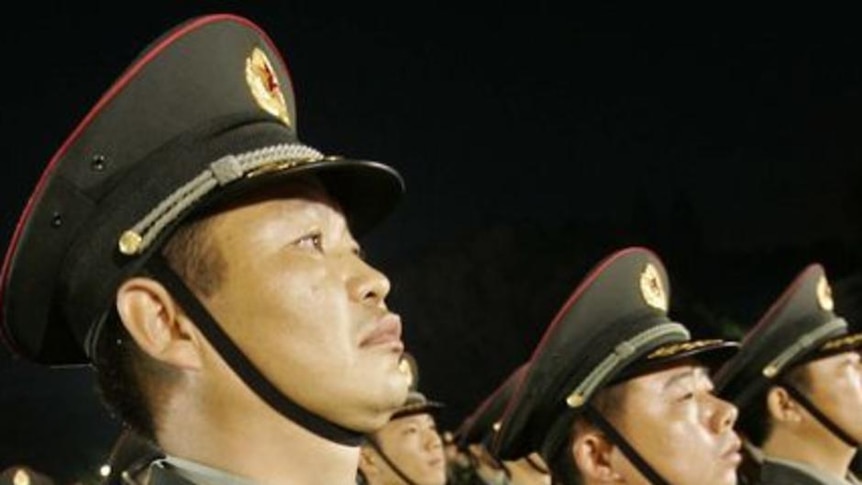 Chinese People's Liberation Army troops stand to attention