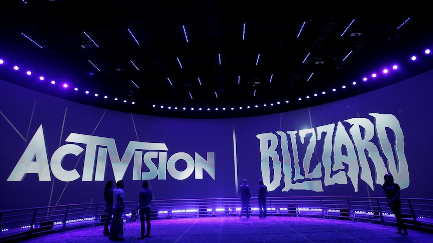 Large Activision and Blizzard logos are brandished on the rounded sides of a large room lit in purple