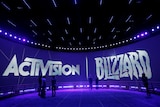Large Activision and Blizzard logos are brandished on the rounded sides of a large room lit in purple